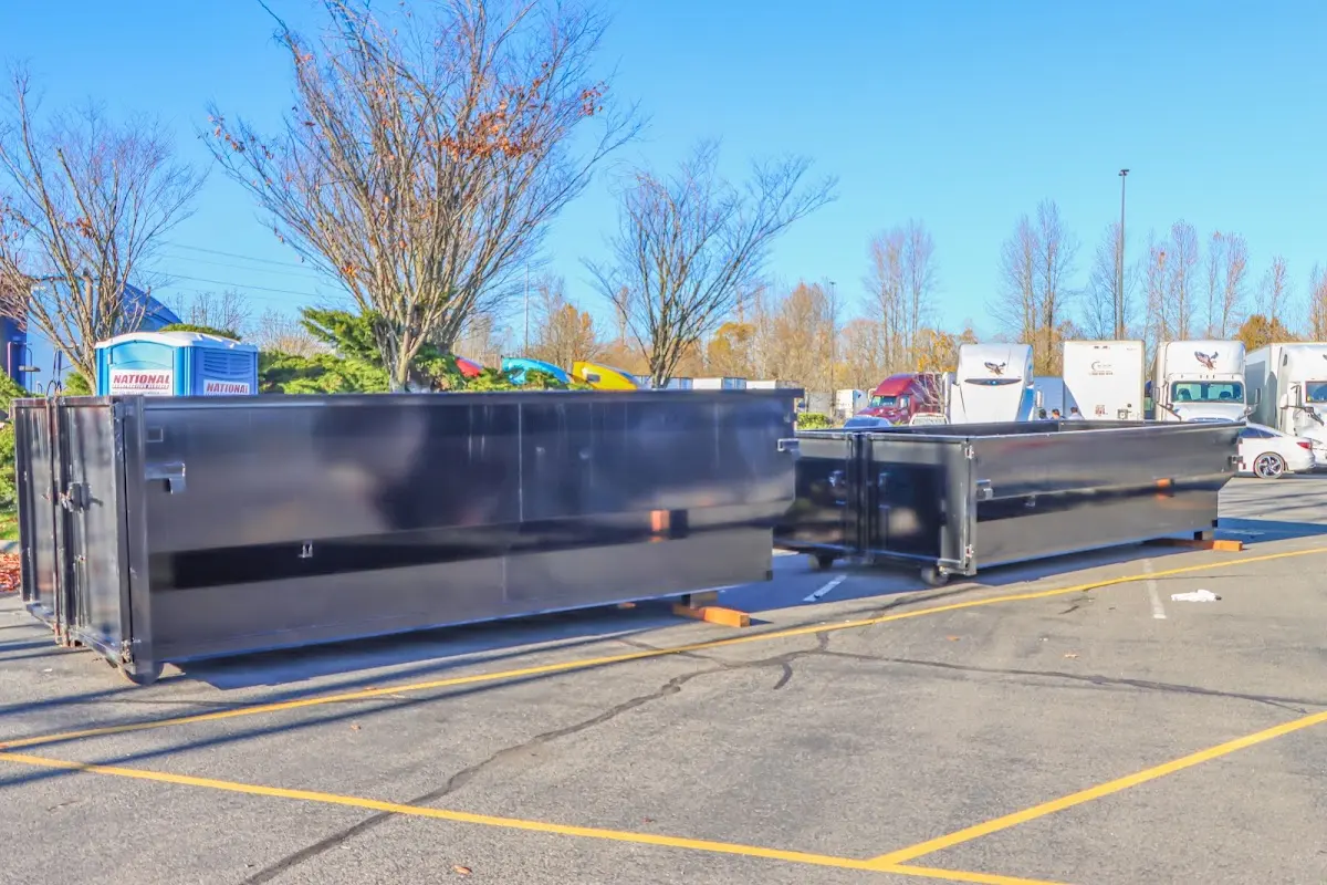Professional dumpster rental service with roll-off container on residential driveway in Caledonia